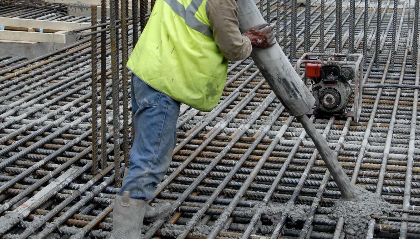 Professional concrete contractor pouring concrete on rebar foundation in Apex, NC